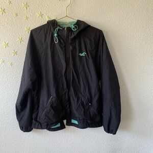 Hollister Co. navy blue windbreaker with turquoise accents